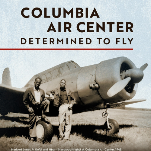 Columbia Air Center - Determined To Fly A black and white image of two men standing in front of an old propeller plane